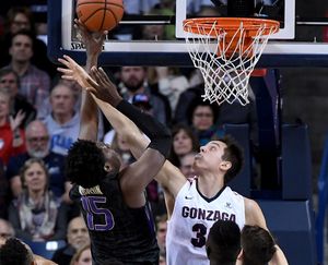 Gonzaga forward Zach Collins (32) fouls Washington forward Noah Dickerson (15) during the first half of a NCAA men's basketball game in the McCarthey Athletic Center. (Colin Mulvany / The Spokesman-Review)