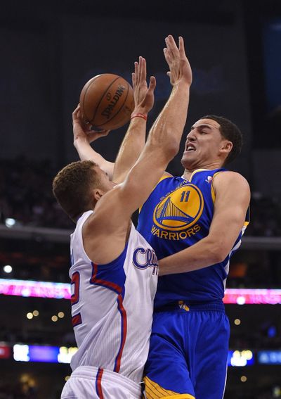 Golden State Warriors guard Klay Thompson, right, puts up a shot as Los Angeles Clippers forward Blake Griffin defends. (Associated Press)