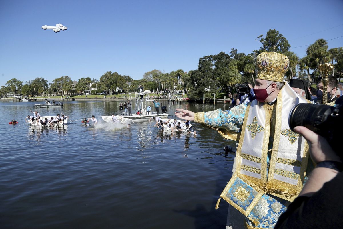 n this Wednesday, Jan. 6, 2021 photo, His Eminence Archbishop Elpidophoros, Primate of the Greek Orthodox Archdiocese of America throws a cross into Spring Bayou during the 115th year of the annual Epiphany celebration in Tarpon Springs, Fla. Leaders of the Greek Orthodox Archdiocese of America said Thursday, Sept. 16, 2021, that while some people may have medical conditions for not receiving the vaccine, “there is no exemption in the Orthodox Church for Her faithful from any vaccination for religious reasons.” Greek Orthodox Archbishop Elpidophoros added: “No clergy are to issue such religious exemption letters,” and any such letter “is not valid.”  (Douglas R. Clifford)