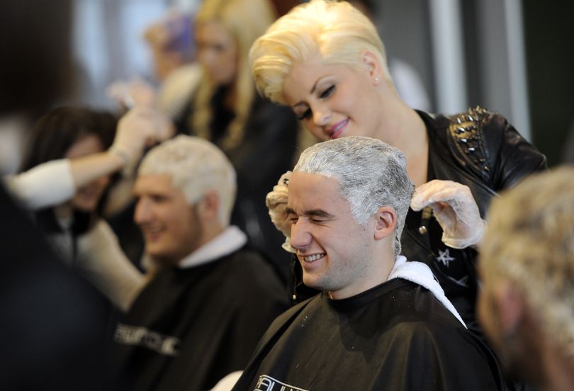 A hair-raising experience. Daisy Daines grimaces while stylist Shawna Indahl bleaches his hair on Wednesday, at Paul Mitchell the School in Spokane Valley. Six Central Valley High School students pledged to bleach their hair if their classmates donated more than $10,000 to the Spokane Valley Partners Food Bank. Students raised $12,600 and the six had their hair done. See the story and more photos on Page 4. (Jesse Tinsley)