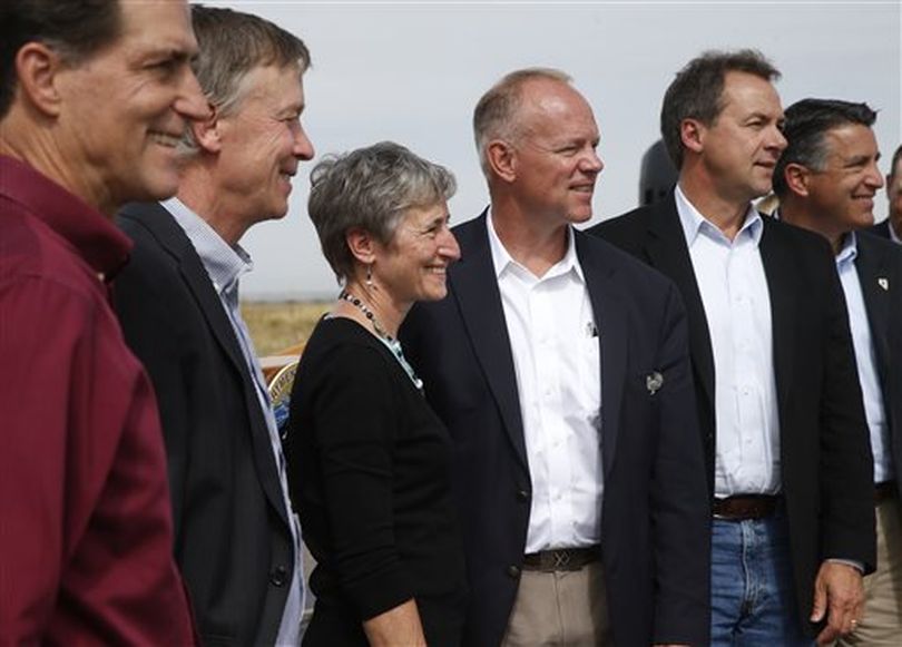 Interior Secretary Sally Jewell, third from left, poses for a group photo with, left to right, Dan Ashe, Director of the U.S. Fish and Wildlife Service, Colorado Gov. John Hickenlooper, Wyoming Gov. Matt Mead, Montana Gov. Steve Bullock, and Nevada Gov. Brian Sandoval, at a gathering where Secretary Jewell made the formal announcement that the greater sage grouse, a ground-dwelling bird whose vast range spans 11 Western states, does not need federal protections, at Rocky Mountain Arsenal National Wildlife Refuge, in Commerce City, Colo., Tuesday Sept. 22, 2015. The Obama administration and affected states have committed hundreds of millions of dollars to saving the grouse without Endangered Species Act protections that many argued would threaten industry. (AP / Brennan Linsley)
