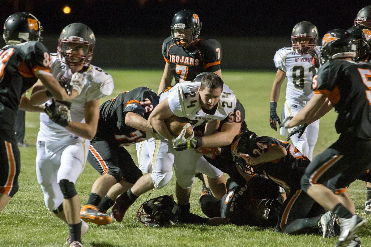 University running back Bryce Williamson battles for extra yards after having his helmet knocked off. He finished with 212 yards. (BRUCE TWITCHELL PHOTOS)