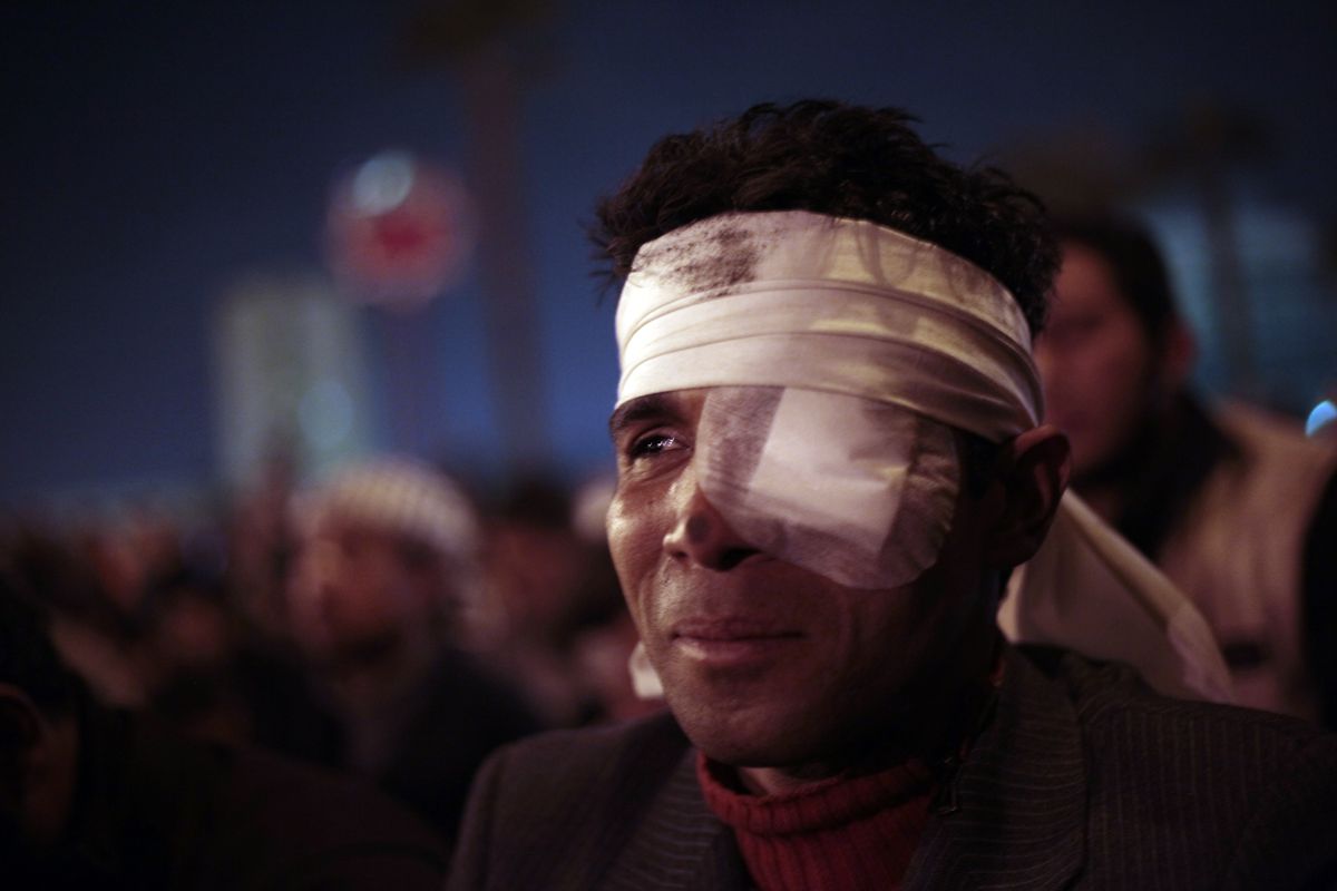 A protester, who said he was wounded during clashes with police in the previous days, weeps as he prays with other protesters in Tahrir square in downtown Cairo, Egypt, Sunday, Jan. 30, 2011. (Lefteris Pitarakis / Associated Press)