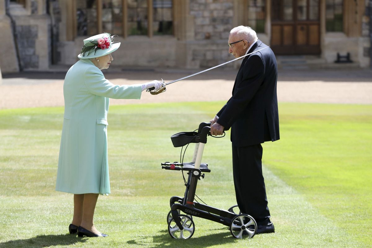 Capt. Sir Thomas Moore receives his knighthood from Britain’s Queen Elizabeth, during a ceremony at Windsor Castle in Windsor, England, Friday, July 17, 2020. Captain Sir Tom raised almost $40 £33 million for health service charities by walking laps of his Bedfordshire garden. ASSOCIATED PRESS  (Chris Jackson)