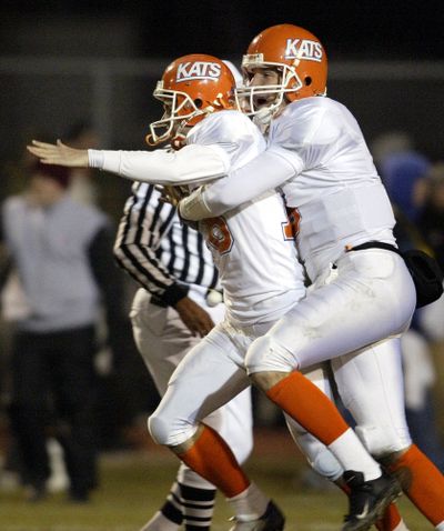 Sam Houston State's Travis Tobaben, right, hugs Lance Garner, left, after Garner kicked the game-winning extra point to beat Eastern Washington 35-34 following a touchdown as time expired in a quarterfinal NCAA Division I-AA playoff game on Dec. 4, 2004, in Cheney, Wash. (Associated Press)