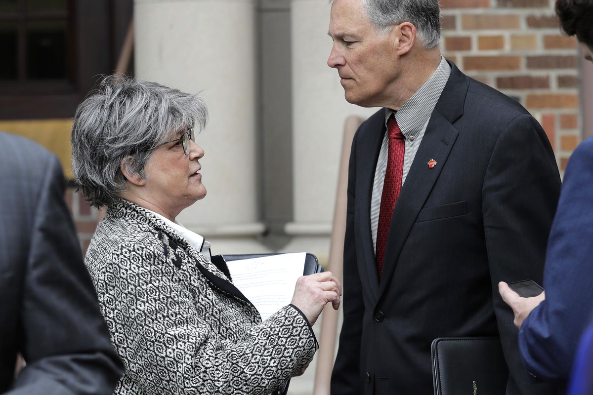 Cheryl Strange, left, secretary of the Department of Social and Health Services, talks with Washington Gov. Jay Inslee, right, following a news conference in Lakewood, Wash., Friday, May 11, 2018. Inslee on Friday outlined a five-year plan for the state’s mental health system that will include ending most civil patient placements at the state’s large hospitals by 2023 in favor of smaller state-run community-based facilities. (Ted S. Warren / AP)