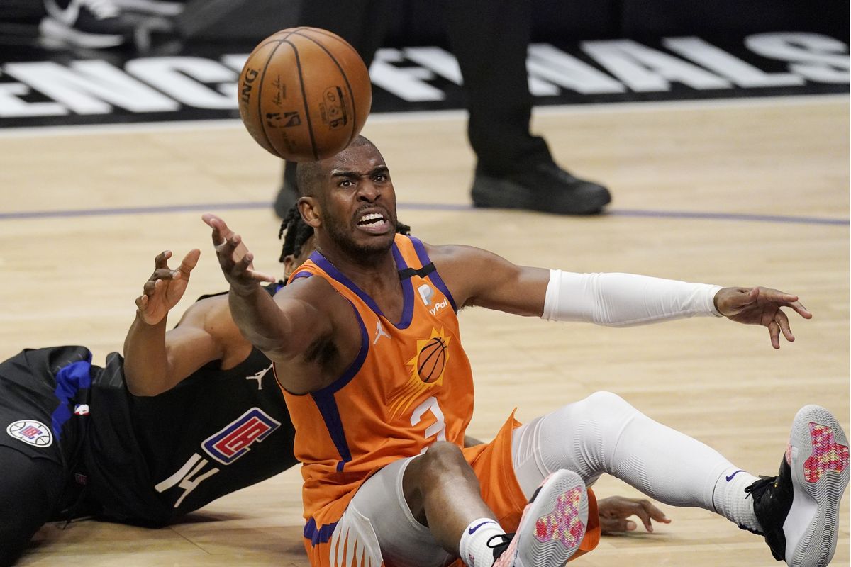 Phoenix Suns guard Chris Paul, right, goes after a loose ball along with Los Angeles Clippers guard Terance Mann during the second half in Game 6 of the NBA basketball Western Conference Finals Wednesday, June 30, 2021, in Los Angeles.  (Mark J. Terrill)