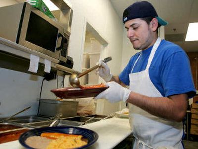 
Rafel Alarcon, a cook at Las Margaritas restaurant in Westerville, Ohio, finishes an order.  U.S. restaurants are slowly moving beyond the fare of tacos, burritos and combo plates that are little more than sanitized versions of the real deal. 
 (Associated Press photos / The Spokesman-Review)