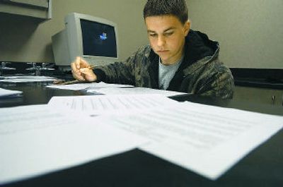 
University High School junior Corey McRae works on his collection of evidence portfolio Thursday. Some schools have such alternatives to retaking the WASL. 
 (Christopher Anderson / The Spokesman-Review)