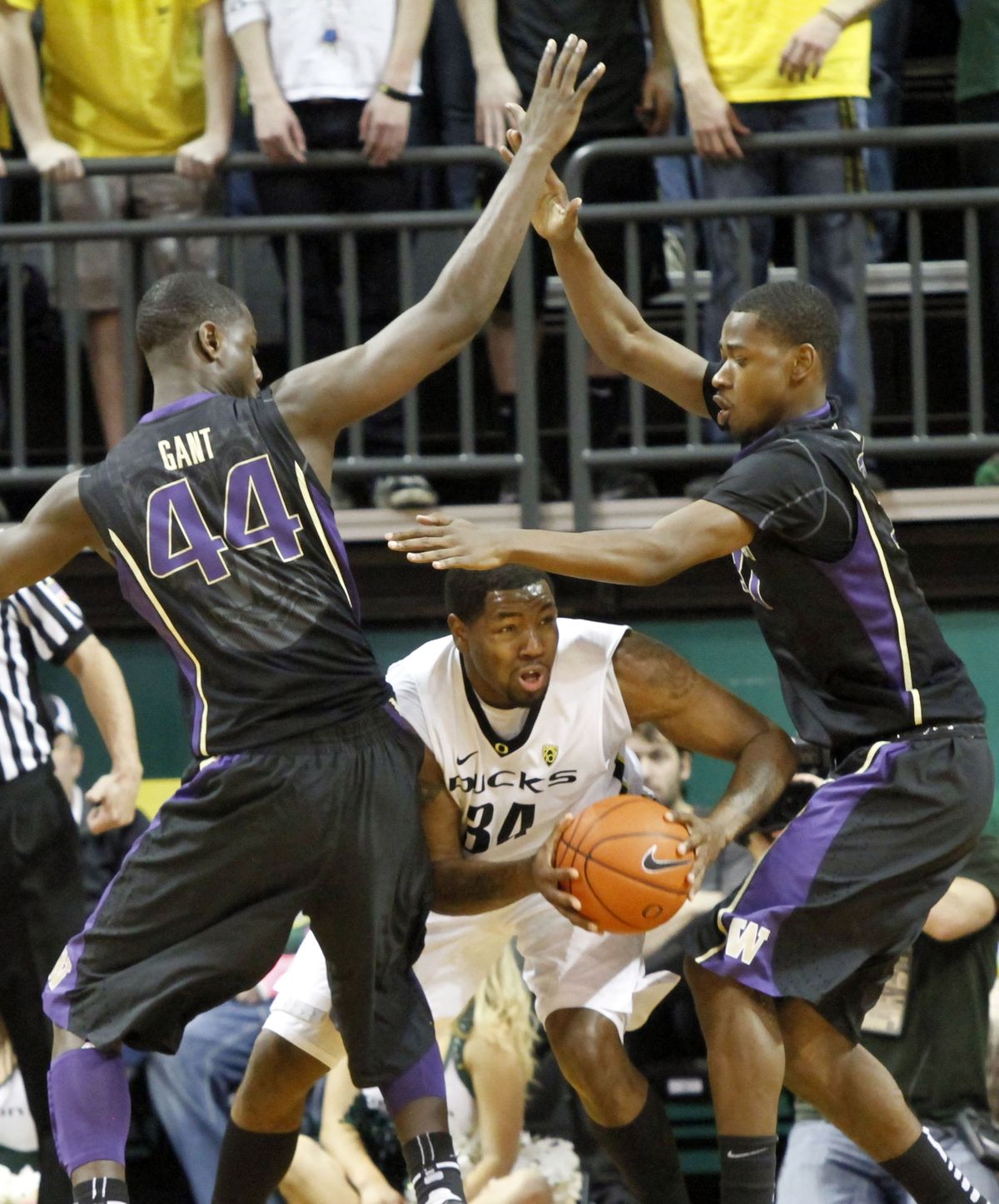 Washington’s Terrence Ross, right, and Darnell Gant trap Oregon’s Joevan Catron. (Associated Press)
