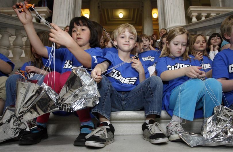 From left, Amanda Arroyo, Brady Moran, and Kiley O'Brien, first-graders at Cumberland Hills Elementary School, wrap up G.I. Joe figures that were launched with parachutes from the rotunda of the Rhode Island Statehouse in Providence, R.I., to open the 2010 International G.I. Joe Collectors' Convention, Friday, April 30, 2010. (Stew Milne / Fr56276 Ap)