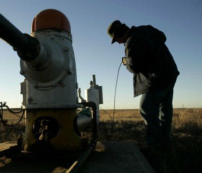 
Kansas Division of Water Resources employee Chuck Schmidt checks the water level of an irrigation well near Ulysses, Kan., earlier this year.  
 (Associated Press / The Spokesman-Review)
