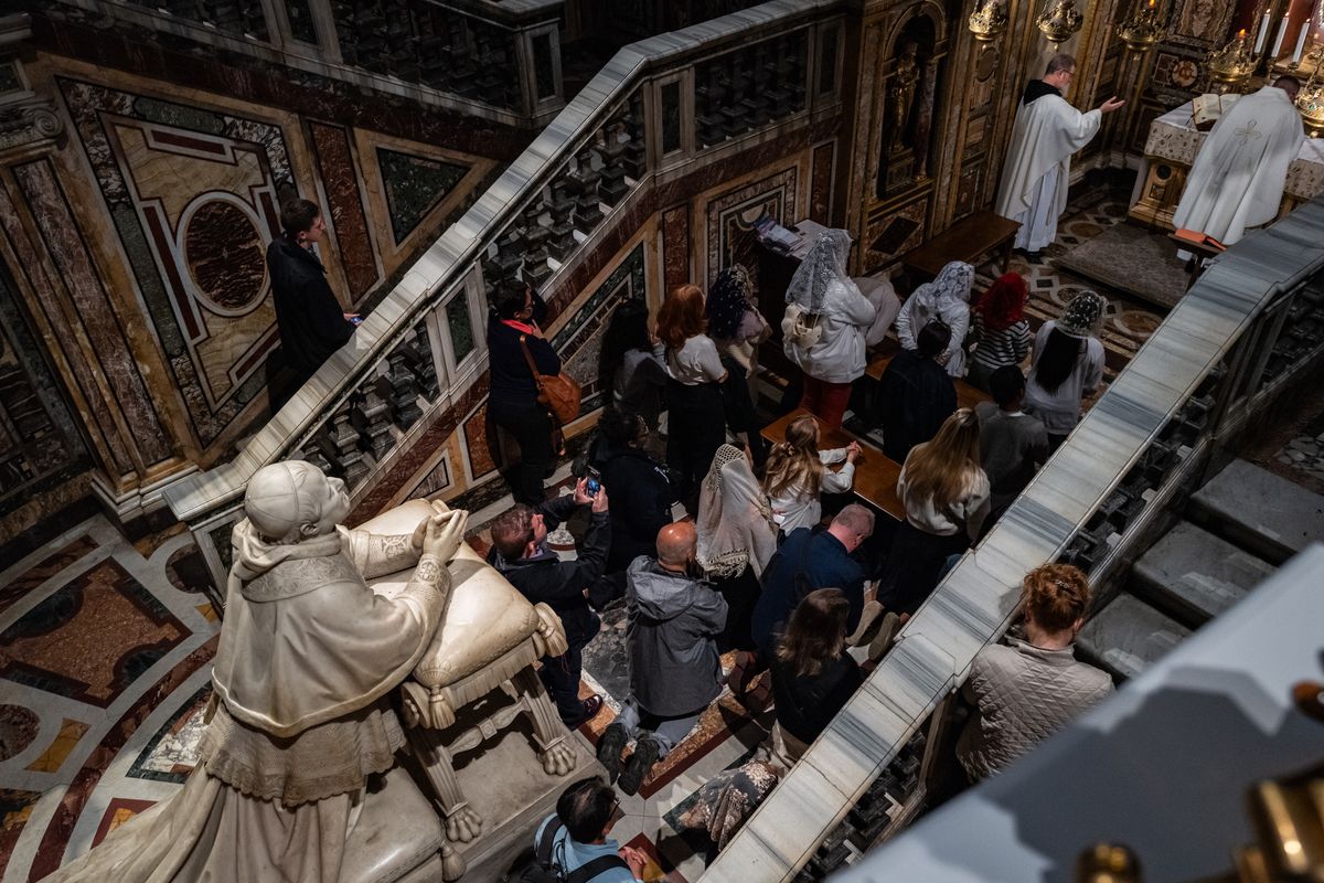 People pray after visiting the tomb of Pope Francis at Santa Maria Maggiore Basilica in Rome on Monday. (Salwan Georges/The Washington Post)