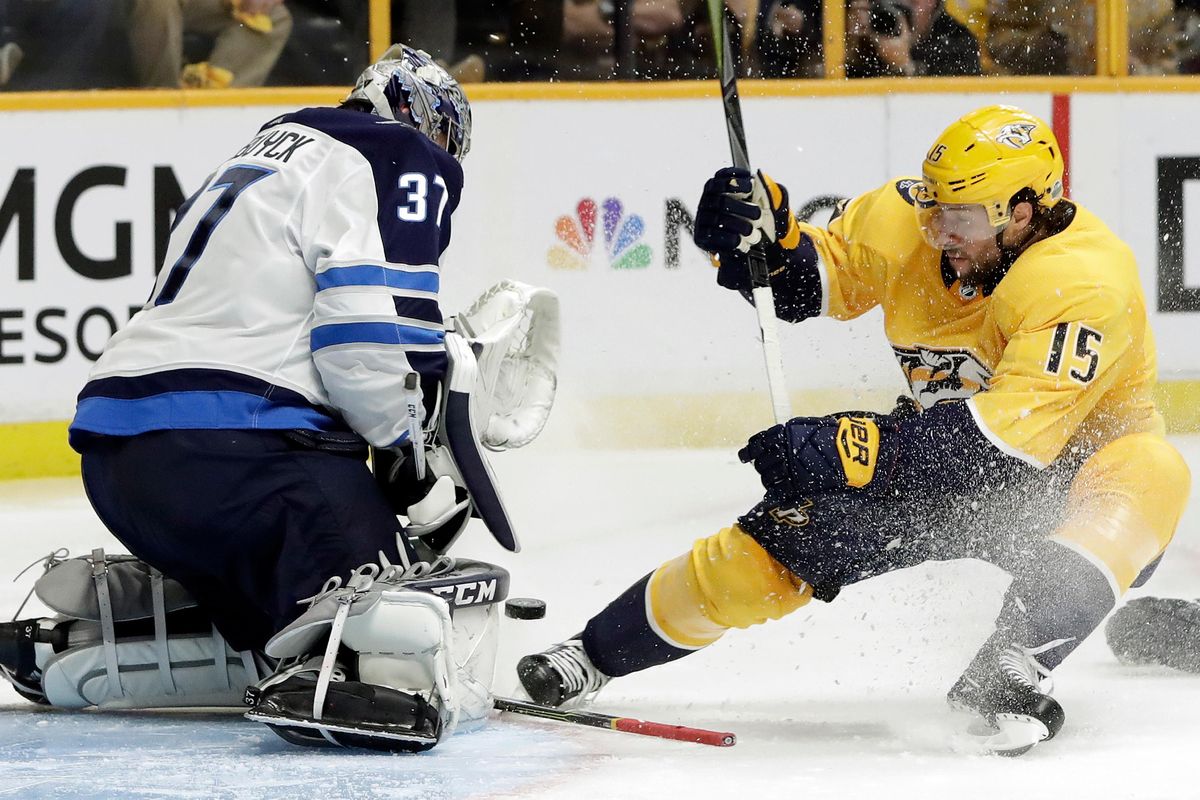 Winnipeg Jets goalie Connor Hellebuyck (37) blocks a shot from Nashville Predators right wing Craig Smith (15) during the second period in Game 1 of an NHL hockey second-round playoff series Friday, April 27, 2018, in Nashville, Tenn. (AP Photo/Mark Humphrey) ORG XMIT: TNMH109 (Mark Humphrey / AP)