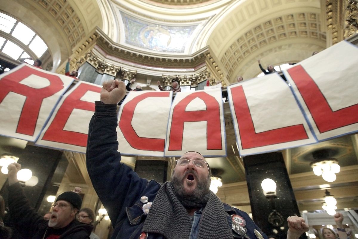 FILE - In this Jan. 17, 2012 file photo, Hallis Mailen, of Madison, Wis., participates in a rally calling for the recall of Gov. Scott Walker at the Wisconsin State Capitol in Madison. Organized labor, blindsided by a new law weakening union rights in Michigan, point to Walker, who raised more than $30 million to beat his Democratic opponent in the June recall, as a prime target in the 2014 elections. (John Hart / Wisconsin State Journal)
