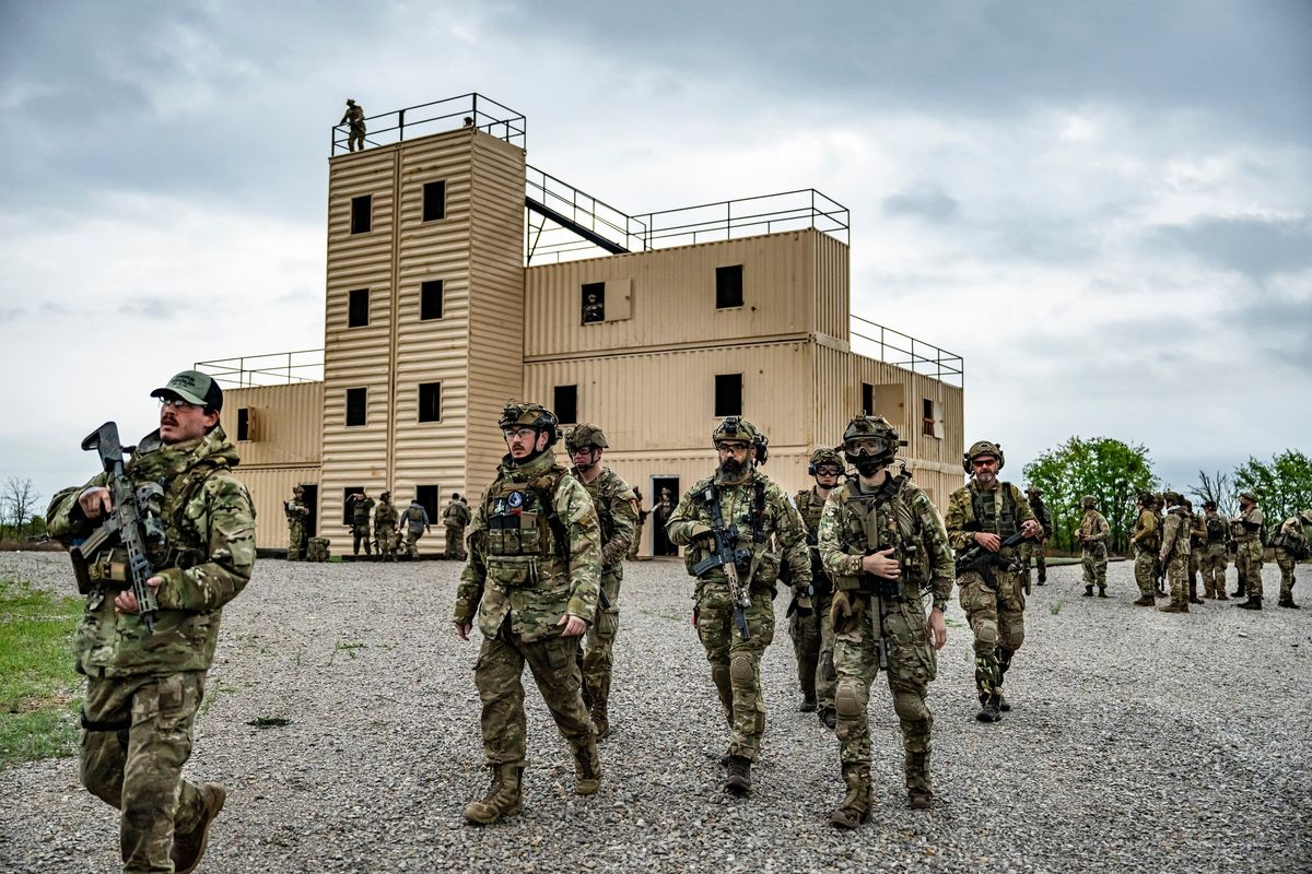 Men playing the part of NATO forces head into the final fictional battle as part of MilSim West, a military simulation company in Overbrook, Okla. on April 20, 2025. A military simulation that looks much like the war in Ukraine attracts a new kind of re-enactment enthusiast, many of whom value military aesthetics over current events. (Meridith Kohut/The New York Time)