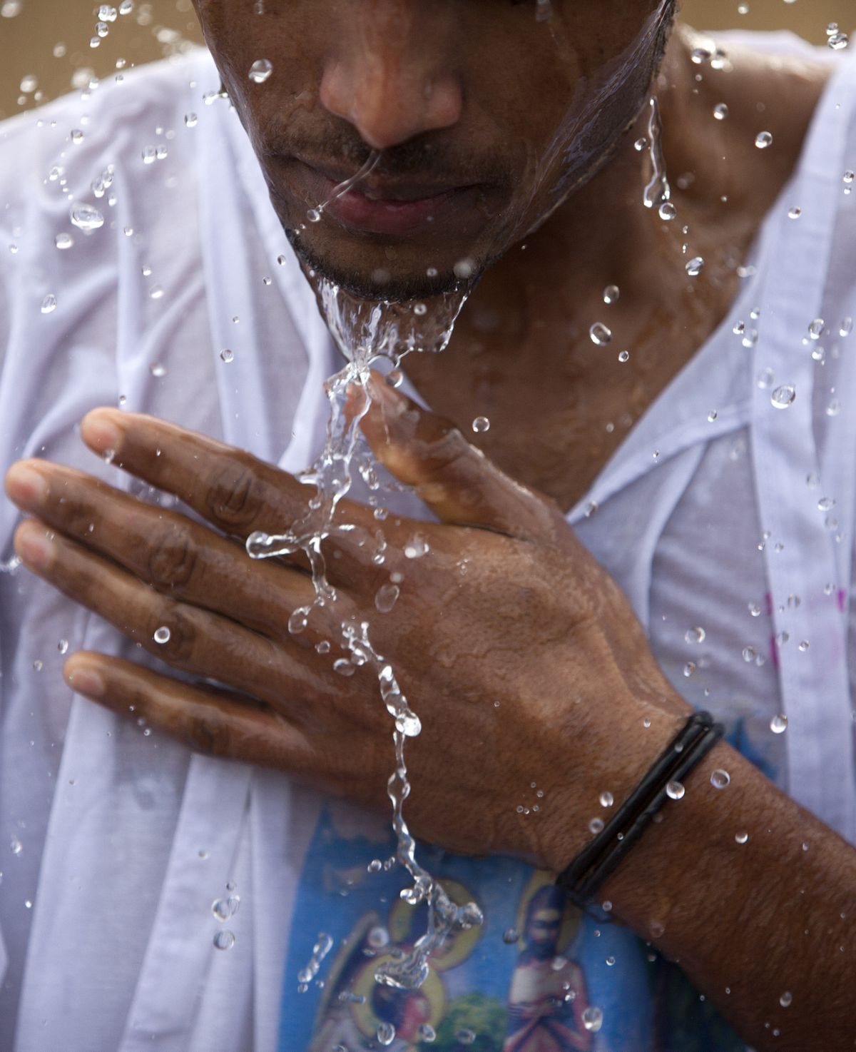 An ethiopian Orthodox Christian pilgrim immerses himself in water from the Jordan River after it was blessed during a baptism at Qasr al-Yahud, near where John the Baptist is said to have baptized Jesus. (Associated Press)