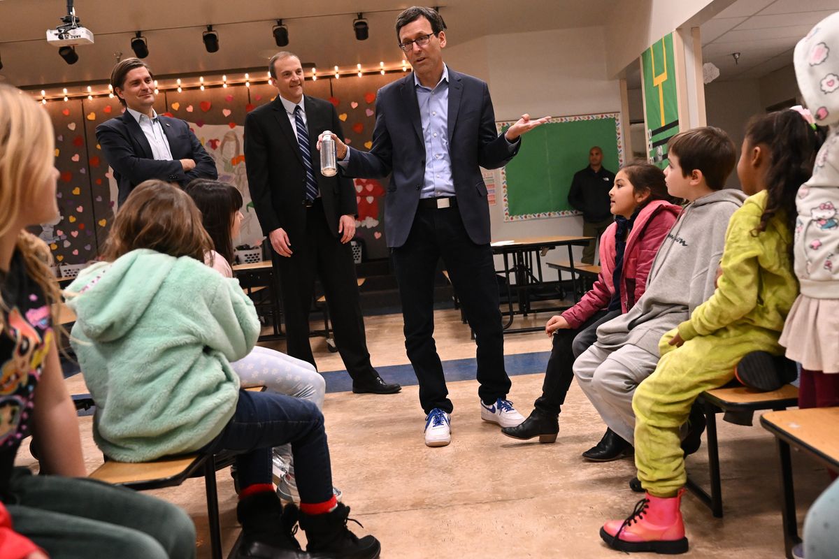 Washington State Treasurer Mike Pellicciotti, left, state Senator-elect Marcus Riccelli and Washington Governor-elect Bob Ferguson visits with Whitman Elementary School students on Friday at Whitman Elementary in Spokane. Ferguson was visiting to talk about free lunch programs for Washington students.  (Tyler Tjomsland/The Spokesman-Review)