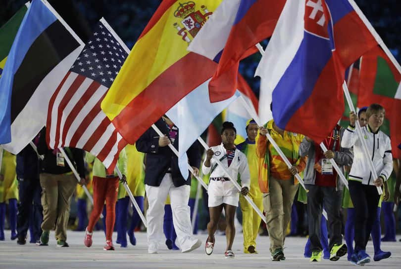 Simone Biles carries the flag of the United States during the closing ceremony in the Maracana stadium as the 2016 Summer Olympics in Rio de Janeiro, Brazil, ended Sunday. (Matt Dunham / Associated Press)