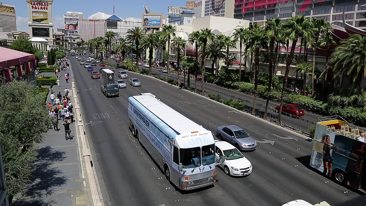 The Hangover Heaven bus makes its way down Las Vegas Boulevard to pick up a patient at a Strip casino on April 15 in Las Vegas. The bus picked up 16 patients on its first weekend as a mobile treatment center for tourists who spent the night before drinking in all the nightlife Las Vegas has to offer. (Associated Press)