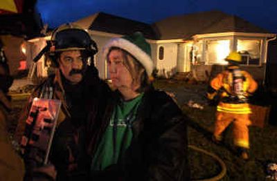 
Karen Brown is questioned Tuesday by firefighters about a fire at her house on Cherry Tree Court in Cheney. 