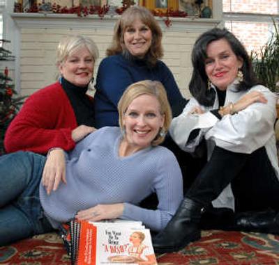 
Catherine Dyer, center, poses with her sisters, Emily Dyer Lynch, left, Margaret Dyer, rear, Lil Dyer Cobbs, right, and their cookbook, in her Atlanta home. The sisters had the book published themselves online using on-demand publishing. Associated Press
 (Associated Press / The Spokesman-Review)