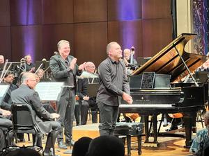 Pianist Mackenzie Melemed bows after playing Amy Beach’s Piano Concerto in C-Sharp Minor, Opus 45, in the Spokane Symphony Master Works concert on Sunday, Sept. 20, 2026. Melemed told the audience that he believes the Spokane Symphony’s performances of the piece on Saturday and Sunday were the first time it was ever played by an orchestra in Washington. Conductor James Lowe applauds behind him. (Jonathan Brunt/The Spokesman-Review)