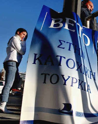 
Greek Cypriots pass behind a banner that reads in Greek 