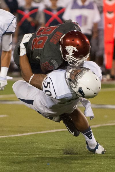 Nevada's Jonathan McNeal (50) tackles Washington State's Isiah Myers (88) during the second half of last  Friday's game in Reno, Nev. Nevada defeated Washington State 24-13. (Associated Press)
