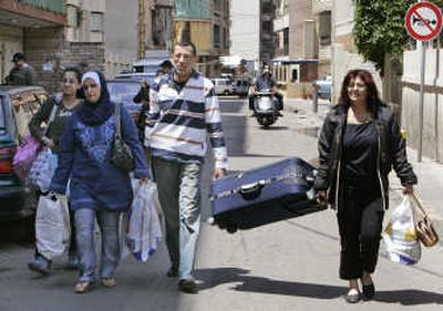 
A Sunni Lebanese family carry luggage as they flee their home in an area taken over by Hezbollah . Associated Press
 (Associated Press / The Spokesman-Review)