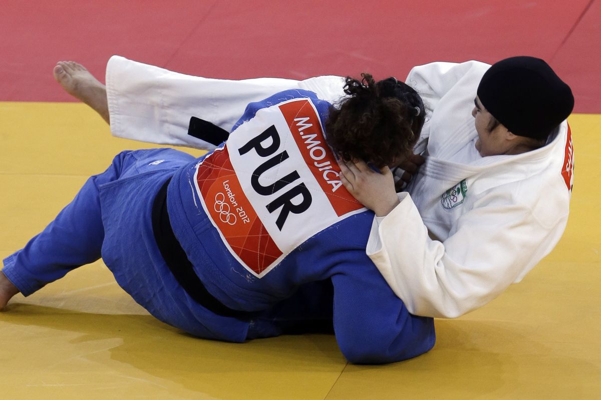 Puerto Rico’s Melissa Mojica put a quick end to her judo match with inexperienced Wojdan Shaherkani of Saudi Arabia on Friday. Afterward, Mojica said “I did not feel pity for her. I felt a lot of respect.” (Associated Press)