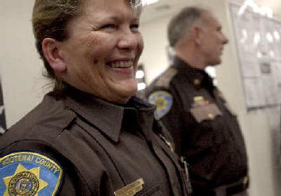 
Sheriff's Sgt. Lisa Carrington sports her department's new uniform next to Sheriff Rocky Watson, who is wearing the old version, at the Sheriff's Department in Coeur d'Alene on Tuesday. 
 (Kathy Plonka / The Spokesman-Review)