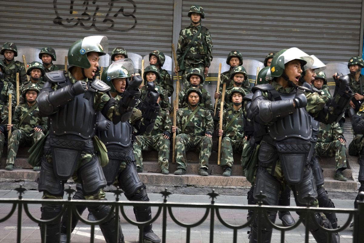 In this July 10, 2009, file photo, Chinese paramilitary police practice during a break from patrol in Urumqi, western China’s Xinjiang province. A group of U.S. lawmakers  urged the Trump administration Thursday, Aug. 30, 2018, to impose sanctions including asset freezes and visa bans on Chinese officials and companies allegedly tied to a stifling security crackdown and the mass internment of ethnic minority Muslims in camps in a far western region. The lawmakers sent a letter to Secretary of State Mike Pompeo and Treasury Secretary Steve Mnuchin urging the government to apply sanctions to address the “ongoing human rights crisis” in the region of Xinjiang, in the latest sign that the detentions are raising concerns among Western leaders and governments. (Ng Han Guan / Associated Press)