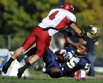 Northern Colorado’s Jace Davis, right, has his helmet knocked off in a collision with Eastern Washington’s J.C. Sherritt on Oct. 16, 2010, at Nottingham Field in Greeley, Colo.  (Eric Bellamy)