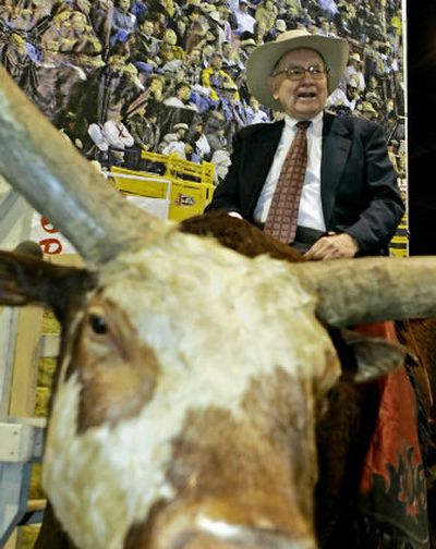 
Warren Buffett rides a stuffed bull at the Berkshire-owned Justin Boots booth during an exhibition hall tour at the annual Berkshire Hathaway shareholders meeting in Omaha, Neb., on Saturday. 
 (Associated Press / The Spokesman-Review)