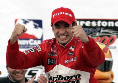 
Helio Castroneves of Brazil celebrates after winning the Firestone Indy 400 at Michigan International Speedway.
 (Associated Press / The Spokesman-Review)