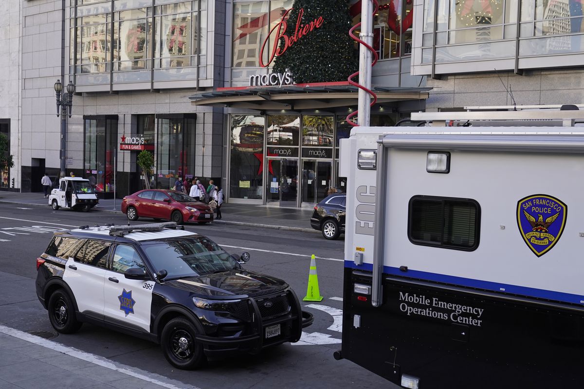 Police vehicles are stationed at Union Square following recent robberies in San Francisco, Thursday, Dec. 2, 2021. In San Francisco, homeless tents, open drug use, home break-ins and dirty streets have proliferated during the pandemic. The quality of life crimes and a laissez-faire approach by officials to brazen drug dealing have given residents a sense the city is in decline.  (Eric Risberg)