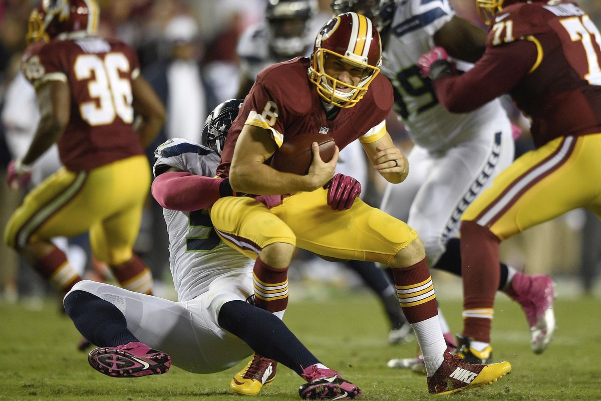 Redskins quarterback Kirk Cousins is sacked by Seahawks middle linebacker Bobby Wagner. (Associated Press)