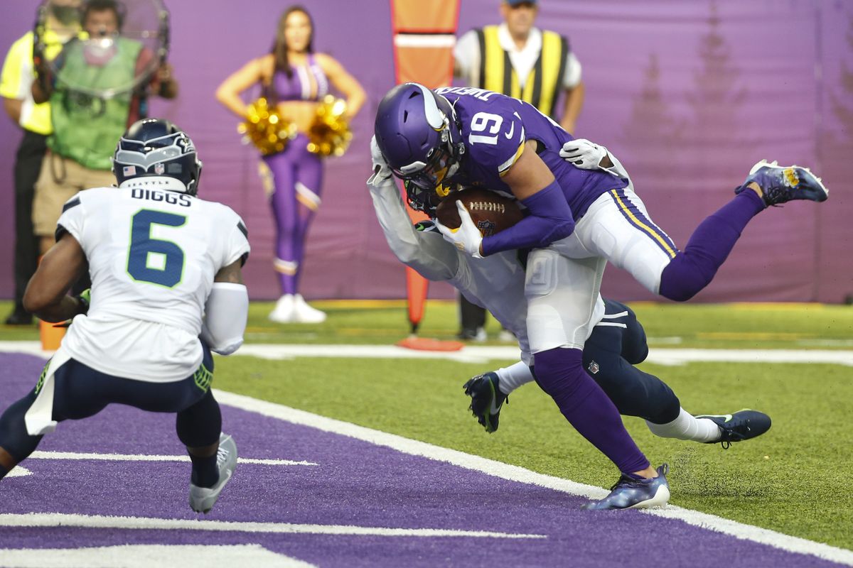Minnesota wide receiver Adam Thielen scores a touchdown in the first half Sunday of a 30-17 victory against Seattle in Minneapolis.  (Associated Press)