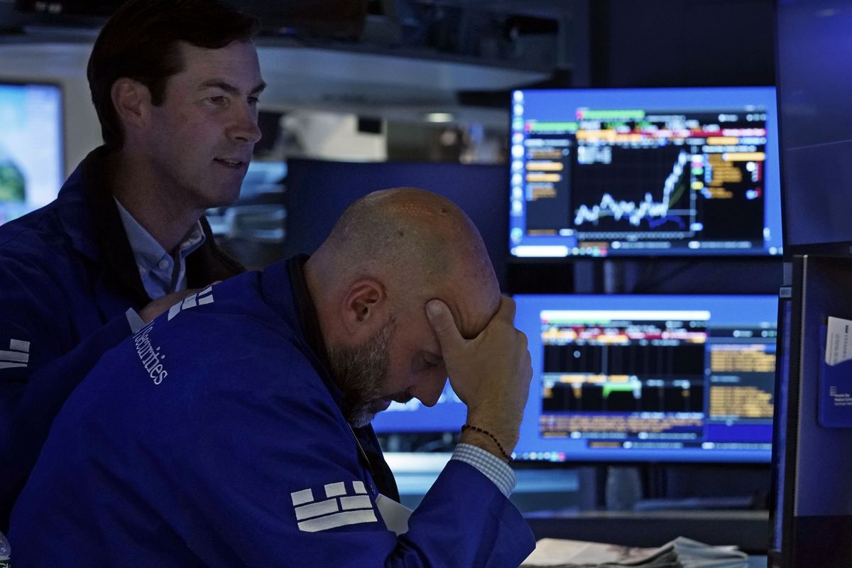 Specialists Specialist John McNierney, left, and Meric Greenbaum work on the floor of the New York Stock Exchange on Tuesday. Technology companies led a broad sell-off in stocks on Wall Street Tuesday, putting the S&P 500 index on track for its biggest drop since May.  (Associated Press)