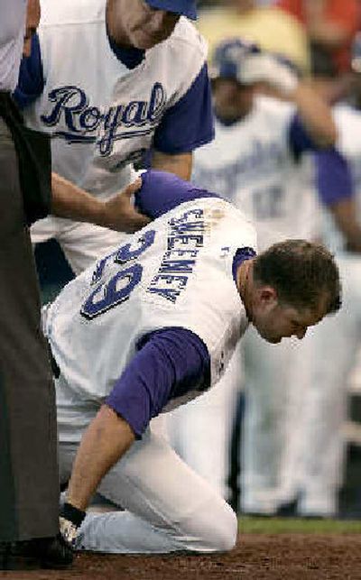 
 Royals' Mike Sweeney is helped to his feet by manager Buddy Bell after Sweeney was hit by a pitch thrown by Mariners starter Aaron Sele.
 (Associated Press / The Spokesman-Review)