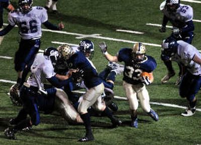
Mead running back Seth Moore dodges through Mt. Spokane's defense during Thursday night's game at Albi Stadium. 
 (Jed Conklin / The Spokesman-Review)