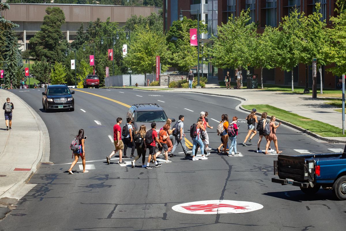Students cross Stadium Way on the Washington State University main campus in Pullman, Wash. on the first day of classes for the 2019-2020 year on Monday, Aug. 19, 2019. (Libby Kamrowski / The Spokesman-Review)