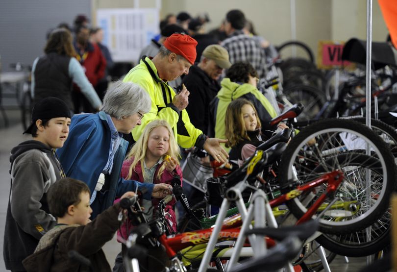 Families, fitness enthusiasts, cycle buffs and first-timers mob the racks of used bikes at the Spokane Bike Swap on Saturday.