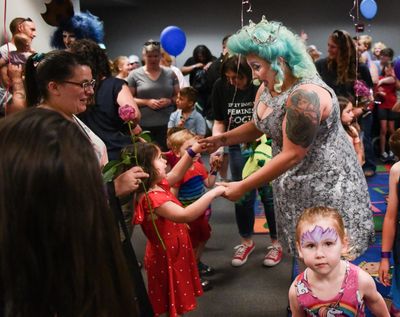 Ruby Heath, left, dances with drag queen Tirrany Hex, right, and other children at the conclusion of Drag Queen Story Hour on Saturday, June 15, 2019, at the South Hill Library in Spokane, Wash. (Tyler Tjomsland / The Spokesman-Review)