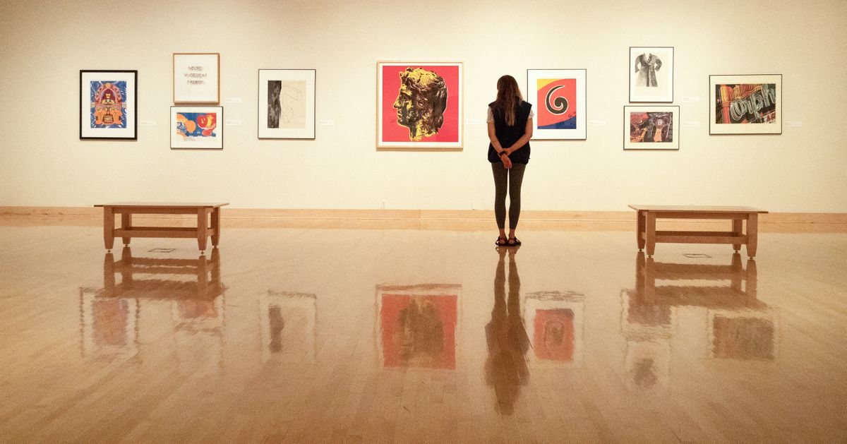 Gallery Attendant Isabella Harris Hamlin observes art in the main gallery of the Jundt Art Museum on April 21, 2021. Jundt is open to the public by appointment with the exhibit "Seven Years of Acquisitions: 2013-2020" on display until May 8.  (Libby Kamrowski/ THE SPOKESMAN-REVIEW)