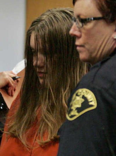
Michele Anderson, accused of killing six members of her family, is led out of court after appearing before a judge Tuesday morning in Seattle. Seattle Times
 (Ken Lambert Seattle Times / The Spokesman-Review)