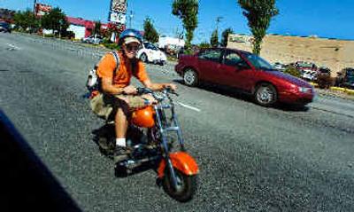 
A scooter heads south on Division on Thursday. The scooters are cheap transportation, but they sit so low to the ground that they can be hard to spot from an SUV. 
 (Christopher Anderson/ / The Spokesman-Review)