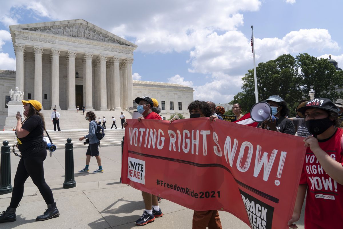 In this Aug. 2, 2021 photo, voting rights activists march outside of the U.S. Supreme Court, during a voting rights rally on Capitol Hill, in Washington. In the nation’s capital on Saturday, Aug. 28, 2021, multiracial coalitions of civil, human and labor rights leaders are convening rallies and marches to urge passage of federal voter protections that have been eroded since the Voting Rights Act of 1965.  (Jose Luis Magana)