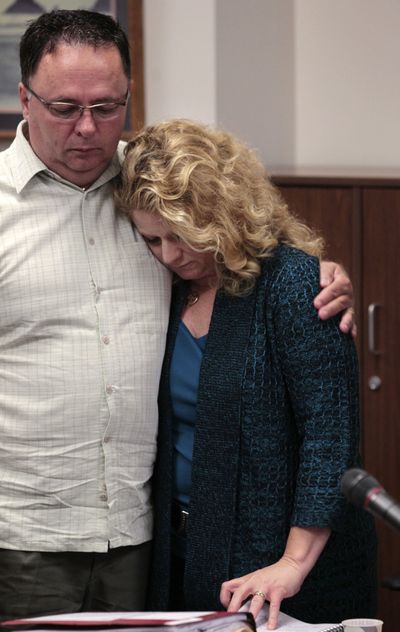 Trisha Conlon, right, is embraced by her husband, Bill Conlon, following a child- custody court hearing Thursday in Seattle. (Associated Press)